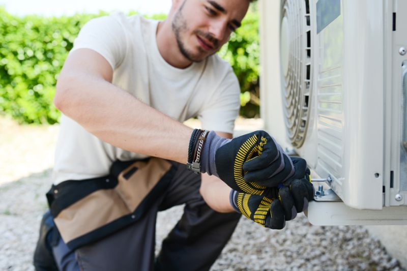 Technician installing HVAC unit.