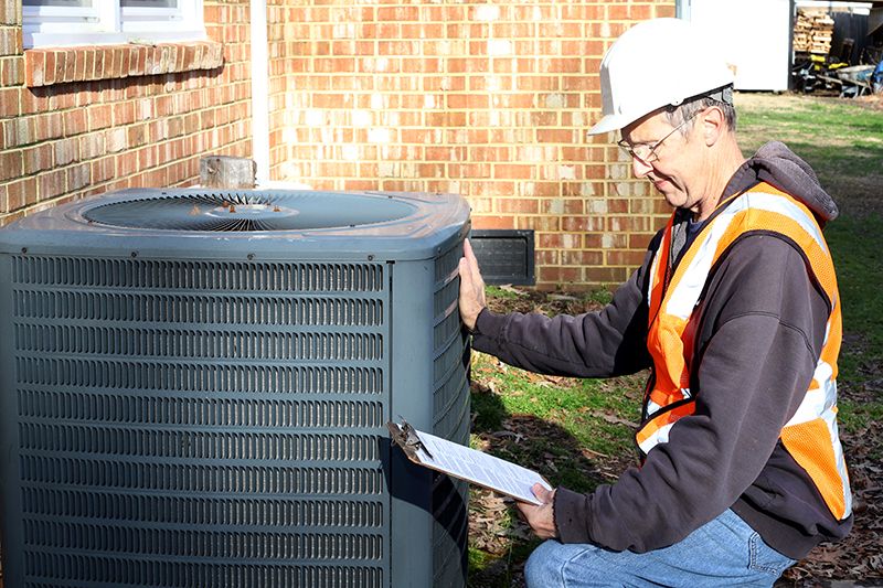 Man installing an HVAC unit.